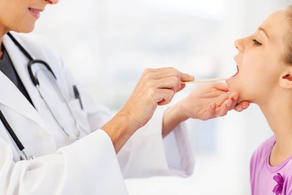 Doctor Examining Girl's Tonsils 